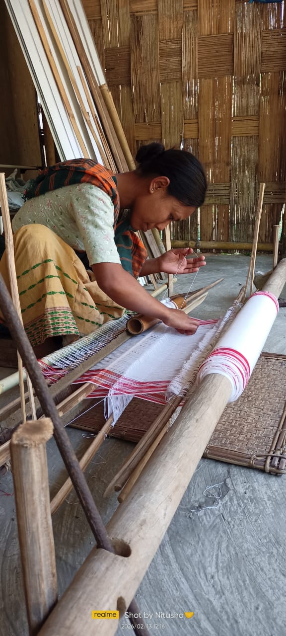Women weaving on handlooms